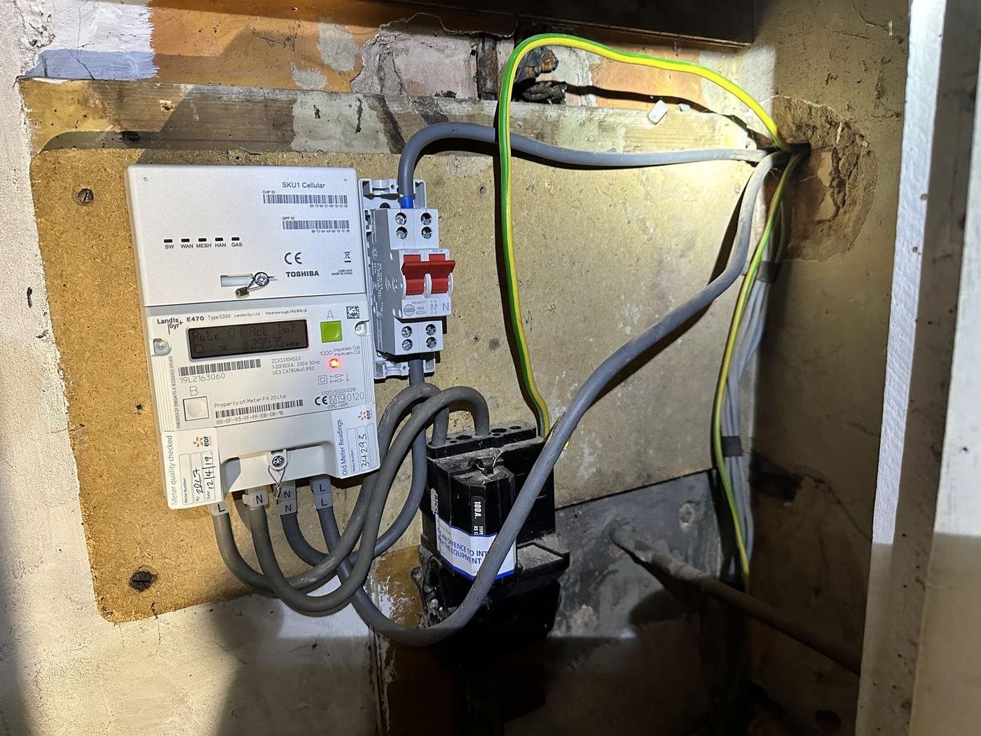 A consumer unit next to an electricity meter