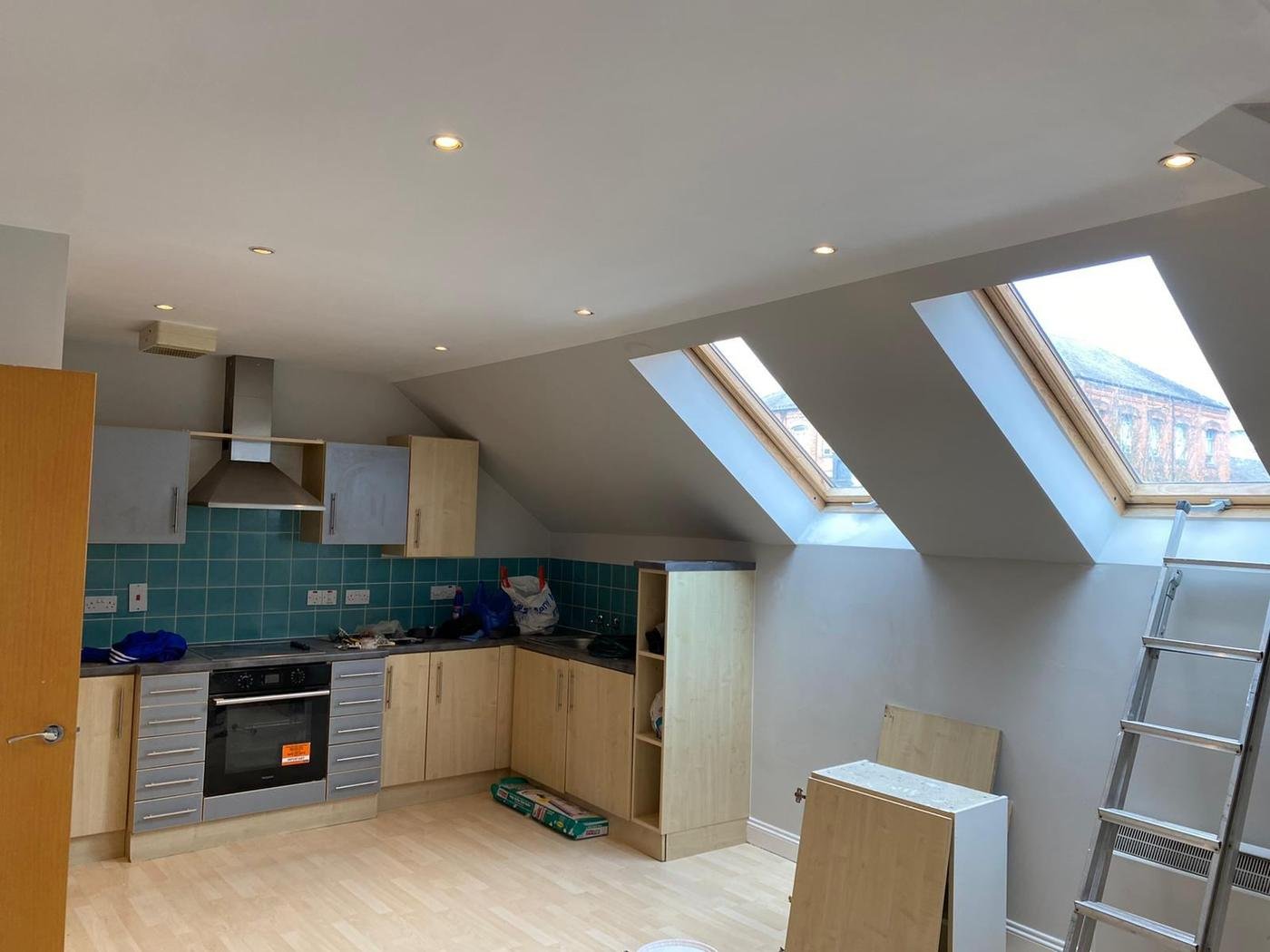 A kitchen fitted under roof windows