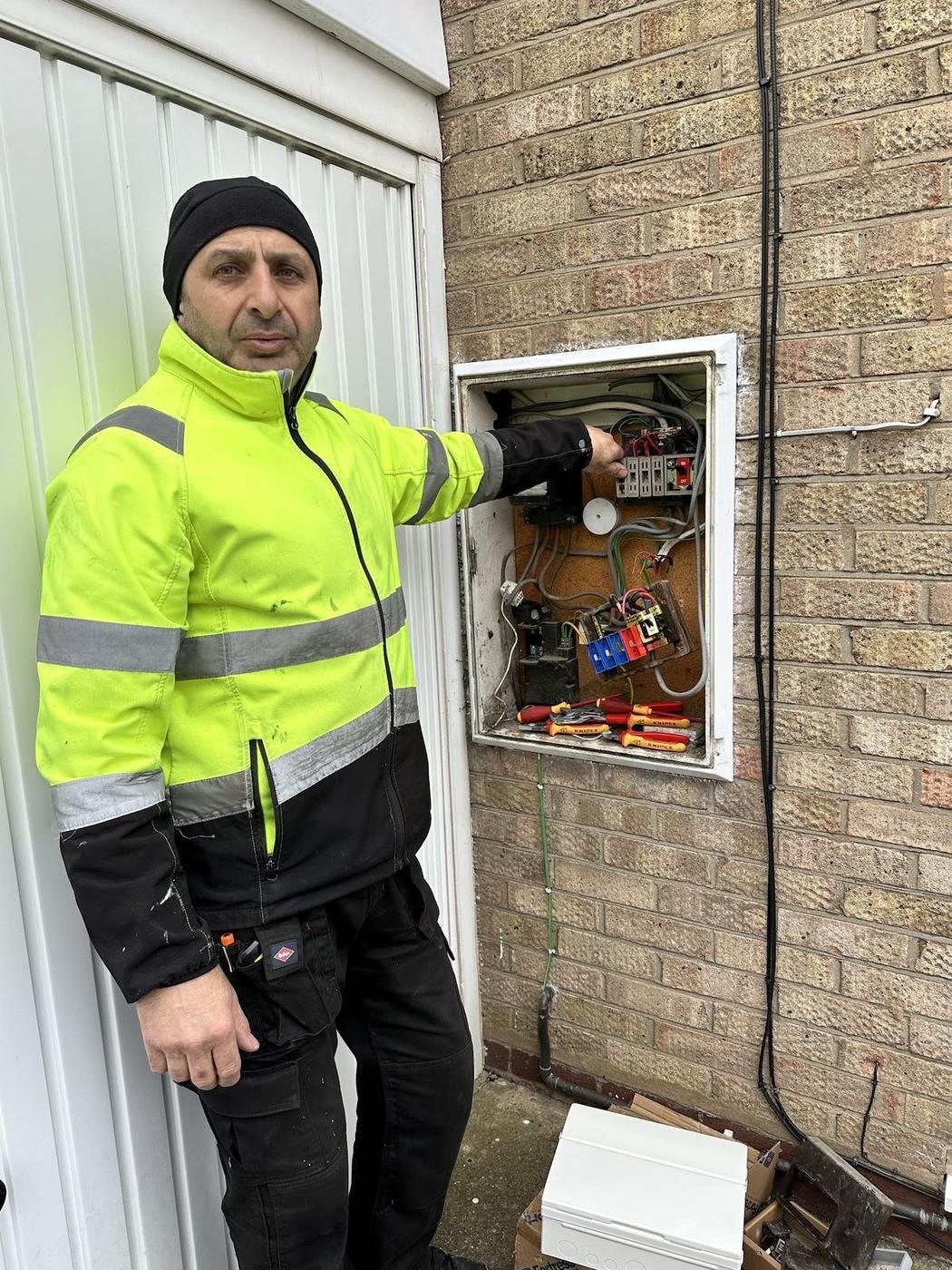 Norman in hi-vis at an outdoor meter box