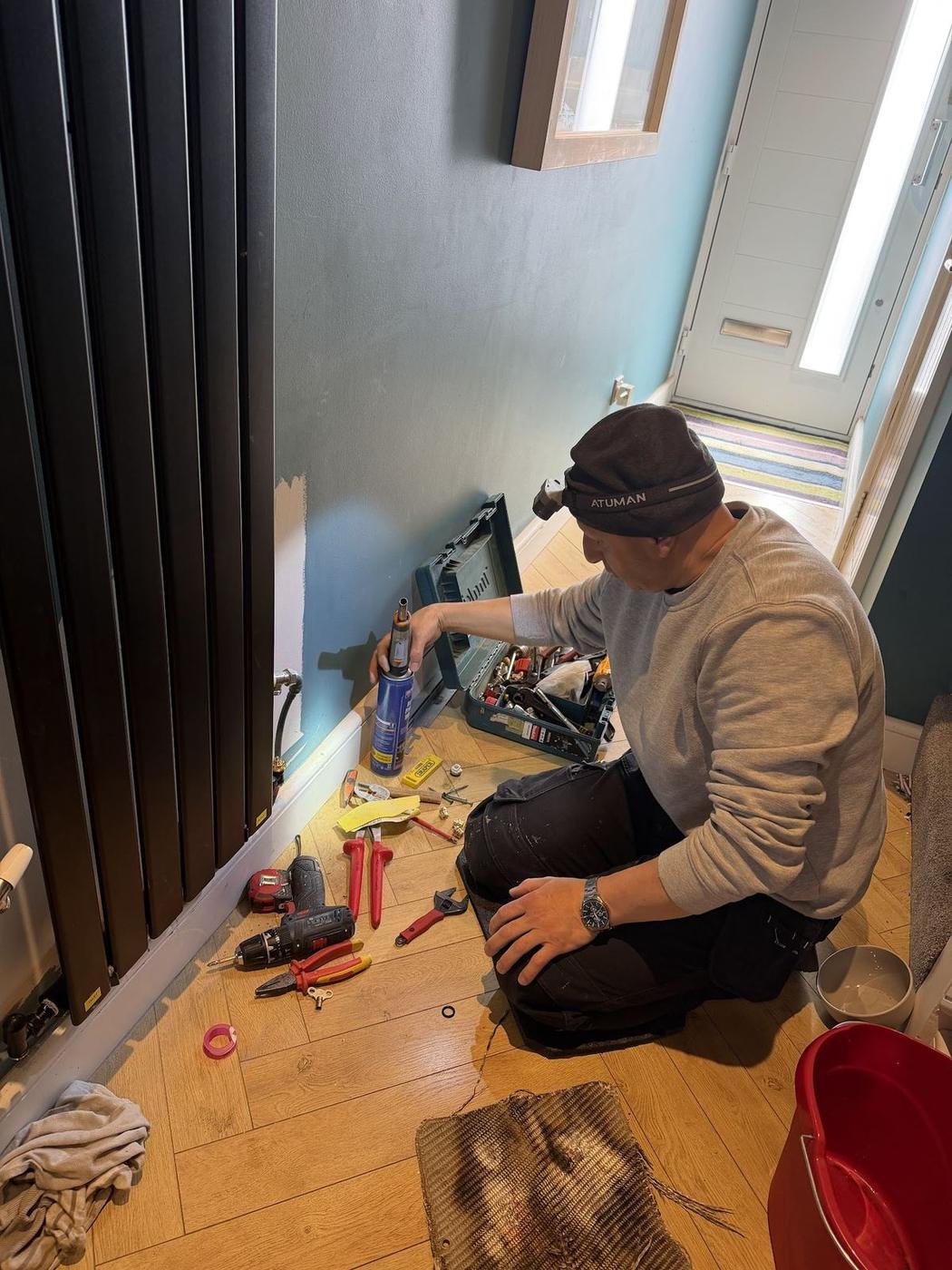Norman working at a black radiator